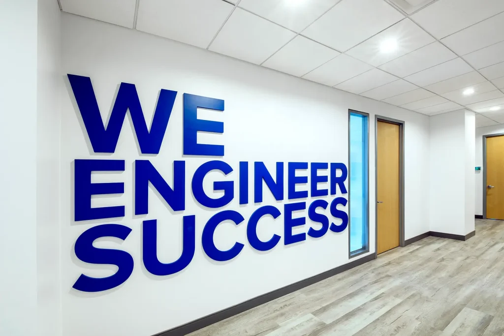 Wall with text "We Engineer Success" written on it